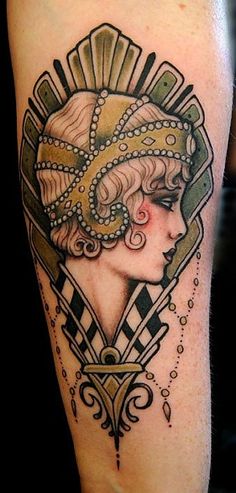 a woman's arm with an art deco tattoo on it