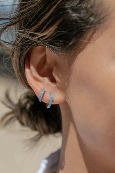 The prettiest blue opal hoops to sweeten your earlobes. These gold and cerulean blue opal huggie hoops shimmy and dance in the light day and night. Team them with with each other or mix and match with our other favorite hoop earrings. ✦ Choose your pair from two different sizes ✦ ✦ DETAILS ✦ ✧ Name: Kehaulani (keh-HOU-lah-nee) - Dew from the sky. ✧ You will receive 1 pair. ✧ Size 1: 10.5 x 2.25mm thick; 8.25mm inner diameter. ✧ Size 2: 12.5 x 2.25mm thick; 9.75mm inner diameter. ✧ Gold Plated St Blue Opal Earrings, Small Gold Hoop Earrings, Gemstone Hoop Earrings, Small Gold Hoops, Tiny Hoop Earrings, Gold Filled Hoops, Cerulean Blue, Summer Earring, Opal Earrings