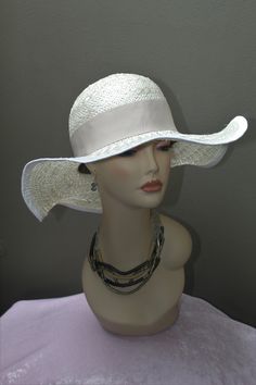 Hand made women's Sisal Sun hat by Alexander & Hallatt in white with beige band. Great feel and movement of pure sisal. Crown is stiffened. Please note that Alexander & Hallatt strive to produce the highest quality hats with minimal synthetic materials (synthetics used in mass produced hats flooding the market). With care, this hat can last a long time. Also note that there will be imperfections, like a stich showing or a line which is not perfect, but this adds to the charm of a true one-of a k White Fitted Brimmed Panama Hat, White Toquilla Straw Hat Band For Summer, White Toquilla Straw Hat Bands For Summer, White Panama Hat With Curved Brim, White Fitted Panama Hat With Curved Brim, Elegant Straw Visor Hat, White Fitted Hat Bands For The Beach, White Fitted Hat Band For Beach, Elegant Beige Visor Sun Hat