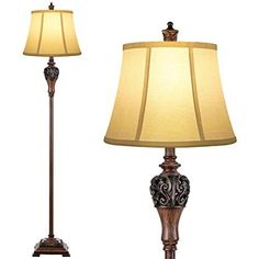 the lamp is next to the floor lamp on the side of the table, which has a brown base and beige shade