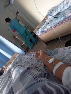 a person laying in a hospital bed with an iv hooked up to their arm and foot