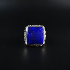 Classic and modern square cabochon blue Lapis Lazuli ring with Sterling silver. Unique gift for her or him, friend, girlfriend, wife, boyfriend, man September and December birthstone, 9 yeaar anniversary. The beautiful royal blue Lapis Lazuli is cut as a classic cabochon and set in Sterling silver with small dots of silver and 18k gold. All our stones are natural stones and our jewelry is handmade, very slight differences may occur in color and size. Our inlay work is all natural stone, NOT pres Blue Rectangular Stone Jewelry Gift, Luxury Blue Square Pendant Jewelry, Fine Jewelry Sapphire Rectangular Jewelry, Sapphire Rectangular Gemstone Jewelry, Silver Rectangular Sapphire Ring, Blue Square Cut Gemstone Jewelry, Square Cut Sapphire Ring For Gift, Luxury Silver Square Jewelry, Square Cut Sapphire Ring As Gift