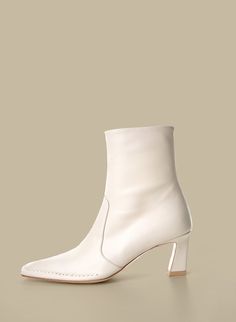 'Je la connais' Calais Ankle Boots in Off-white are square toe shape with front stitched detailing. Tonal stacked leather heel. Leather and rubber outsole in beige. Details: * Composition - Upper: Sheep skin - Lining: Pigskin - Sole: Leather, Rubber *Heel Height: 60mm *Color: Off white Modern White Heeled Boots With Sculpted Heel, Cream Heeled Boots With Reinforced Heel, Cream Pointed Toe Calf Leather Boots, Cream Leather Square Toe Heels, Cream Leather Square-toe Heels, Cream Pointed-toe Calf Leather Boots, Cream Leather Heels With Square Toe, Beige Square Toe Heels With Reinforced Heel, Cream Square Toe Leather Heels