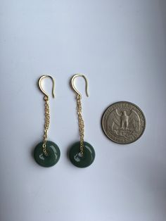 A gorgeous pair of dark green jade donut earrings. The royal style long dangles gold earrings, paired with the vintage green jade circles are eye-catching and elegant. Hade made with high-quality materials only and comes in the gift-worthy package, perfect as a gift for yourself or your loved ones. Some highlights of this pair of breath-taking natural green jade drop earrings are: *High-quality guaranteed Hand made with grade-A natural dark green jade. The chain is gold plated, ensure long lasti Jade Drop Earrings With Ear Wire, Jade Dangle Earrings For Pierced Ears, Handmade Jade Drop Earrings, Natural Stone Jade Dangle Earrings, Round Jade Jewelry With Matching Earrings, Single Green Round Earring, Green Single Round Earring, Nickel-free Round Jade Earrings, Pierced Jade Dangle Earrings