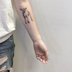 a small lamb tattoo on the left inner arm and wrist, by an artist who has done it