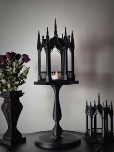 a candle sits on top of a table next to two vases with flowers