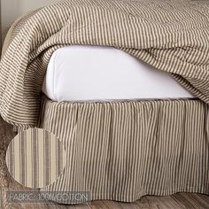 a bed with a striped bedspread and white pillows on top of the headboard