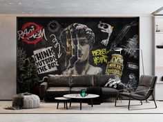 a living room filled with black furniture and graffiti on the wall behind it's couch