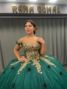 Regal Emerald Green Quinceañera Dress with Gold Embroidery and Off-Shoulder Design Step into your special celebration with this show-stopping emerald green Quinceañera dress that exudes luxury and grace. Crafted with intricate gold embroidery, this gown features a full ball gown skirt that flows beautifully to the floor, complete with a stunning golden lace trim for a truly regal look. The fitted bodice is adorned with delicate golden details and sparkling accents, creating a striking contrast against the deep green fabric. The off-shoulder design adds an element of elegance, framing the neckline with soft, floral accents. Perfect for a quinceañera or any formal event, this gown ensures you'll be the center of attention on your big day. ✨ Key Features: *Color: Deep Emerald Green with Golde Green Ball Gown For Quinceanera, Green Ball Gown Quinceanera Dress For Prom Season, Green Ball Gown For Prom Season Quinceanera, Fitted Green Quinceanera Dress For Debutante Ball, Green Ball Gown For Prom Season, Green Fitted Ball Gown Quinceanera Dress, Fitted Green Ball Gown Quinceanera Dress, Fitted Green Quinceanera Dress For Prom Season, Embellished Green Ball Gown