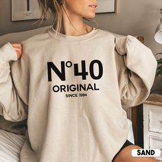 Looking for a unique and personal 40th birthday gift? Look no further than this cute No 40 Original sweatshirt! It's the perfect way to show your loved one how much you care on their special day. Not only is it stylish, but it also makes a great gift for her birthday or any other special occasion.  * Q U I C K * F A C T S * ✺ 50% cotton, 50% polyester ✺ Medium-heavy fabric ✺ Wash and dry normally (on cool for best results) ✺ Product color may slightly vary due to photographic lighting sources or Funny 40th Shirts, 40th Themes For Women, 45th Birthday Shirt Ideas For Women, Funny 50 Year Old Shirts, 40th Female Birthday Ideas, Big 40 Birthday Ideas For Women, 40th Birthday Sweatshirt, Birthday Sweatshirt Ideas, 40th Birthday Tshirts Woman