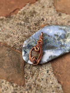 This lovely blue jasper stone is wire wrapped in copper wire. This wire wrap pendant is very elegant and unique. The bail is very simplistic with weaving curling down the front and sides of this polished stone. I added a unique bead at the bottom within the weaving to add character. This pendant would be a great gift for friends and loved one. Many individuals use crystals as healing stones. It is up to you decide what your intentions are.  Dimensions: 2" Tall 1" wide .25" thick I price my wire weaved pendants based on the weight of the stone, by price per gram, and how long it took me to wire wrap each stone, as well as the price on the potency and quality of my minerals, and the amount of materials it took. I find my research from The Audubon Society Field Guide to North American Rocks a Healing Hand-wrapped Moss Agate Jewelry, Ocean Jasper Wire Wrapped Pendant Necklaces, Wire Wrapped Ocean Jasper Pendant Necklaces, Wire Wrapped Ocean Jasper Pendant Necklace, Wire Wrapped Jasper Pendant Necklace, Hand-wrapped Jasper Pendant Necklace, Hand Wrapped Agate Pendant Jewelry, Hand Wrapped Jasper Pendant Necklace, Artisan Jasper Jewelry Gift