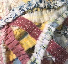 an old quilt that has been made into a piece of cloth with different colors and patterns