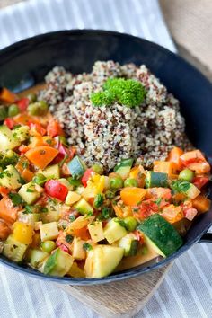 a bowl filled with rice and vegetables on top of a table