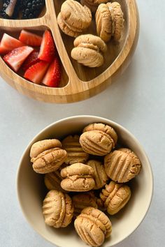 two bowls filled with fruit and nuts next to each other