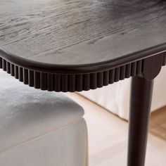 a wooden table sitting on top of a white couch