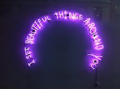 a purple neon sign that says, be careful things around you are doing something right now