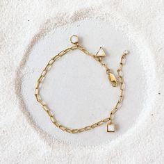 Introducing our Paperclip Charm Bracelet, the embodiment of style and personality. This substantial bracelet boasts a chunky chain design crafted from premium 14-karat gold-fill, making it both opulent and durable. It features a charm addition that reveals your unique personality. Meant to be worn daily and effortlessly stacked with your other favorites, it's the ultimate expression of your style. Choose one charm in your favorite shape and color. Add more to customize and make it as full as you Gold-tone Brass Bracelet With Solid Link Construction, Modern Adjustable Brass Chain Bracelet, Gold-tone Brass Bracelets With Solid Link, Metal Charm Bracelet With Tarnish-resistant Rectangular Links, Everyday Gold Chain Bracelet With Oyster Design, Gold-tone Brass Chain Bracelet Gift, Gold-tone Brass Chain Bracelet As Gift, Gold-tone Brass Chain Bracelet For Gift, Yellow Gold Chain Link Brass Bracelet