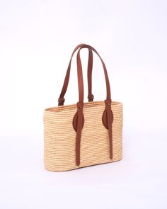 this stunning raffia handmade bag to our customers. This versatile bag can be used as both a shoulder bag and a handbag, making it the perfect accessory for any woman. The natural and eco-friendly raffia material used in this bag makes it a great choice for those who value sustainability. The bag comes in natural raffia color and black , so you can choose the one that best suits your personal style. Our skilled artisans have crafted this bag with traditional techniques and attention to detail, e Eco-friendly Brown Satchel For Vacation, Leather Summer Bag For Everyday Use, Summer Leather Bags For Everyday Use, Chic Handwoven Natural Bucket Bag, Chic Handwoven Natural Fiber Bag, Woven Palm Leaf Shoulder Bag For Vacation, Eco-friendly Palm Leaf Shoulder Bag For Vacation, Chic Woven Natural Fiber Shoulder Bag, Chic Natural Handwoven Bucket Bag