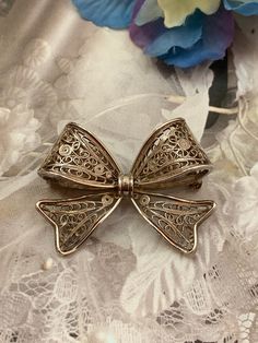 This is a lovely, elegant vintage Cannetille -  filigree bow brooch/pin!  Excellent vintage condition! It comes from a Norwegian private collector. Marked and tested sterling silver! PLEASE look at ALL pictures for measurements and condition as they are a very important part of the description, and what you will receive! Pictures are made with different light! Please note that this is sold "As Is", no returns please! N.V. Vintage Filigree Brooches, Ornate Silver Filigree Brooches, Vintage Silver Filigree Brooches, Gold Vintage Brooch With Bow, Vintage Gold Brooch With Bow, Scandinavian Jewelry, Wedding Brooch, Different Light, All Pictures