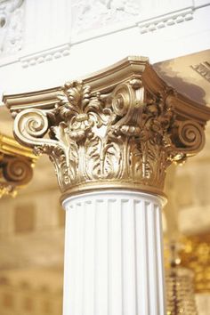 a white column with gold decorations on it