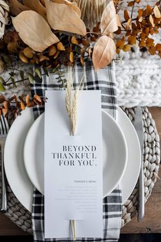 a table setting with white plates and black and white plaid napkins that say, beyond thank you for you