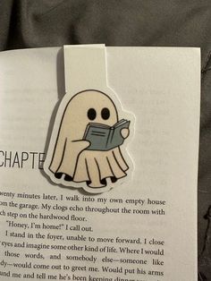 an open book with a ghost holding a book in it's hand and the text on top