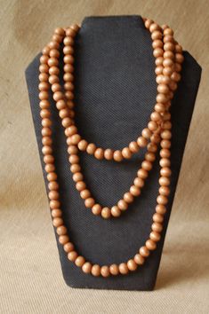 ~PLEASE READ FULL LISTING DESCRIPTION BEFORE PURCHASING~ Hand made wooden beads necklace. Wooden beads are stained and varnished. The cord is organic cotton. Sizes: large 36''long(72'' circular) or x-large 60''long (120'' circular) Shown in 36'' size. The length of the necklace is not adjustable. The length is not a circular measurement. 36'' or 60'' is measured from the neck down. 36'' necklace will give you 2 or 3 wraps around your neck and 60'' necklace will give you 3 to 5 wraps around your Burlap Gift Bags, Wooden Bead Necklaces, Wooden Necklace, Beads Handmade, Beads Necklace, Natural Brown, Wooden Beads, Gift Bag, Color Options