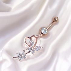 Super cute y2k 2000s rose gold diamond rhinestone butterfly heart dangling belly piercing ring bar.  Surgical steel  FREE STANDARD UK SHIPPING Elegant Body Jewelry With Bling For Gifts, Elegant Metal Belly Rings As Gift, Elegant Metal Belly Rings For Gift, Elegant Heart-shaped Belly Rings, Elegant Metal Dangle Belly Rings, Dangle Cubic Zirconia Body Jewelry As A Gift, Dangle Metal Belly Rings, Dangle Body Jewelry For Gifts, Dainty Dangle Body Jewelry