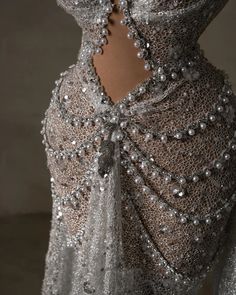 the back of a woman's dress with beads on it