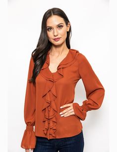 Earn up some serious style points while wearing this Urban Edge Ruffled Blouse on your next day out. Decorated with ruffle trim detailing that traces all the way from the neckline to the hem, this stylish blouse features a V-neckline and long sleeves with elasticated ruffle cuffs. It has a button fastening for closure on the front. *Polyester *Machine wash recommended *Front button fastening for closure *Ruffle trim detailing buttoned cuffs Chic V-neck Blouse With Ruffle Hem, Fall V-neck Top With Ruffle Hem, Fall V-neck Ruffled Tops, Elegant Ruffle Hem Tops For Work, V-neck Ruffled Blouse For Work, Elegant Tops With Ruffle Hem And Ruffle Sleeves, V-neck Ruffles Blouse For Work, Elegant Ruffle Sleeve Tops With Ruffle Hem, Elegant Tops With Ruffle Hem And Sleeve