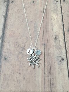 "This listing is for a hand stamped initial necklace featuring a 4/5\" x 3/5\" silver plated edelweiss charm, 1/5\" birthstone pendant, & 3/10\" stainless steel initial pendant. The silver plated chain is 18\" long, but can be made to your desired length- see last photo in listing. Please indicate the chain length you would like in the 'notes to seller' section at checkout. All items are lead & nickel free. Message me with any questions, thank you! Add an initial to any necklace https://www.etsy Edelweiss Necklace, Edelweiss Jewelry, Baby Shower Jewelry, Texas Jewelry, Name Necklace Silver, Wolf Necklace, Jewelry Nature, Equestrian Jewelry, She Wolf