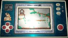 an old nintendo game and watch sitting on a table