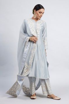 Teal blue kurta with princess-cut, placement floral motif parsi gara embroidery and pearl lace border. Comes with dogri salwar and silk organza dupatta.
Component: 3
Embroidered
Neckline: Band Collar
Sleeve Length: Three Quarter
Fabric: Kurta: Chanderi Silk; Salwar: Bamber Satin; Dupatta: Silk Organza
Color: Blue
Princess-cut
Concealed placket
A-line silhouette - Aza Fashions Salwar Pants, Blue Kurta, Pearl And Lace, Indian Suits, Fancy Dress Design, Organza Dupatta, Embroidered Neckline, Indian Fashion Designers, Silk Organza