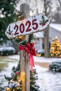 a wooden pole with a christmas tree on it and a sign that says 2055