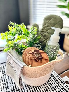 a basket filled with green plants and personal care items sitting on top of a table