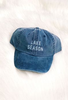 Charlie Southern Lake Season Hat, blue denim hat with adjustable strap and blue embroidered lake season on the front Outdoor Denim Blue Hat, Spring Outdoor Denim Hat, Adjustable Distressed Blue Hat, Casual Distressed Outdoor Hats, Casual Distressed Hats For Outdoor, Distressed Medium Wash Adjustable Hat, Distressed Blue Hat With Adjustable Fit, Casual Dark Wash Adjustable Hat, Summer Outdoor Denim Hats