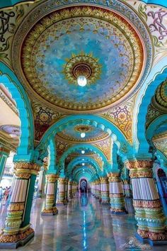 the inside of an ornate building with blue and gold paint on it's walls