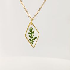 Gold necklace with real pressed fern leaf in resin Terrarium Jewelry An elegant resin necklace with real green hand-picked forest fern. This will be a special gift for a loved one, as ferns symbolize sincerity towards others. If you are giving someone a fern as a gift, you are giving them the hope that they will have confidence, shelters, wealth, and happiness. This is a great plant to give someone that you really care about. Charm size: 24x9mm (0.94 * 0.35 inch) Non-tarnished gold-plated stainl Mother's Day Nature-inspired Pendant Necklace, Delicate Green Birth Flower Jewelry, Delicate Green Jewelry With Birth Flower, Minimalist Pressed Flower Necklace For Mom, Delicate Green Necklace For Gift, Green Pendant Necklace As Keepsake, Green Pendant Necklace For Keepsake, Minimalist Pressed Flowers Necklace Gift For Mom, Nature-inspired Leaf-shaped Jewelry With Pressed Flowers