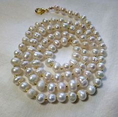 Shop now one of a kind single strand sweatwater pearl chain. It's made of large round shaped pearls with gold colored metal spacer beads incorporated between the pearls. This nice handmade necklace can be a beautiful bridal accessory. Chain length - 24.5 inches - 62 cm Pearl diameter - 5-6 mm Please see more jewelry here https://www.etsy.com/shop/LaceMiracle?ref=seller-platform-mcnav&section_id=28462737 Ready to ship. Wonderful Christmas gift for someone you love. Also please mind that due t Rondelle Single Strand Pearl Necklace Gift, Single Strand Rondelle Pearl Necklace Gift, Gift Single Strand Rondelle Pearl Necklace, Gold Rondelle Pearl Necklace As Gift, White Oval Beads Pearl Necklace As Gift, Pearl White Necklace With Oval Beads For Gift, Pearl White Pearl Necklace With Oval Beads For Gift, White Oval Bead Pearl Necklace For Gift, White Oval Beads Pearl Necklace Gift