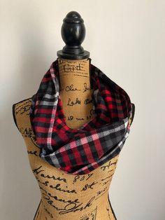 "This infinity pocket scarf is in the softest flannel.  A good choice for a man or a woman.  It's great for making a quick trip to the store or when you don't want to carry your purse.    It's also great for those sporting events where you can't take your purse or backpack, and for traveling to stash your passport, money, cards, cellphone, etc. to protect from pickpockets.   The pockets are unlined and sewn directly into the scarf. Color: Red, black, gray, and white check/plaid. Material: Cotton Flannel Scarf, Flannel Scarves, Pocket Scarf, Plaid Material, Pocket Scarves, Travel Scarf, Scarf Infinity, Money Cards, Scarf Men