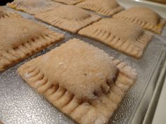 several pastries are sitting on top of a baking sheet, ready to be baked