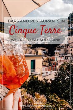 a person holding up a wine glass with oranges in it and the words, bars and restaurants in cinque terre where to eat and drink