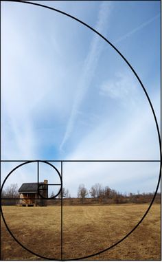 an open field with a house in the background and a circular design on the ground