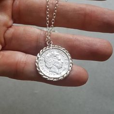 Coin pendant necklace, comprised of a delicate silver necklace with an old British coin pendant, great for everyday wear, unique and beautiful. The chain is made of 925 sterling and the pendant is an original coin which I decorated with twisted silver wires. This coin necklace is a great gift for women and a perfect necklace for bridesmaids Materials: This coin necklace is also available in gold plated brass pendant with a 14k gold filled chain (see last 2 photos). Dimensions: The pendant's diam Vintage Silver Coin Charm Necklaces, Sterling Silver Coin Pendant Medallion Necklace, Vintage Sterling Silver Medallion Necklace With Coin Pendant, Silver Sterling Silver Coin Pendant Necklace, Sterling Silver Coin Pendant Charm Necklaces, Sterling Silver Medallion Charm Necklace With Coin Pendant, Sterling Silver Coin Medallion Necklace, Silver Minimalist Medallion Coin Necklace, Minimalist Sterling Silver Medallion Necklace With Coin Pendant