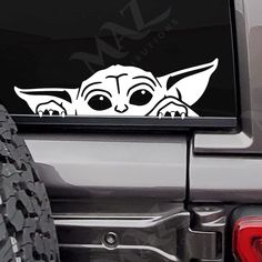 the baby yoda sticker is on the back of a car