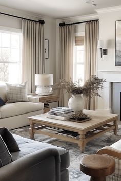 a living room filled with furniture and a fire place in front of a window covered in curtains