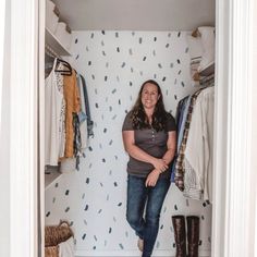 a woman is standing in the closet with her legs crossed and smiling at the camera