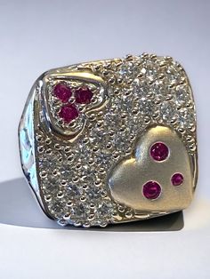 "Estate 14k White Gold BIG and BOLD 2 CTW Diamond Ruby Statement Heart Ring GORGEOUS! This beautiful vintage ring is sure to become a treasured heirloom! * Crafted with intricate detail, the beautiful large square face is a encrusted with beautiful round bright diamonds! * Ring face measures approximately 3/4\" across! * Round cut rubies are set into the hearts on face. * There are twenty nine (29) approximately .06 ct round diamonds set flush in this large square face ring! There are a total of Heart Cut Multi-stone Anniversary Rings, 14k Heart Cut Diamond Ring For Valentine's Day, 14k Stamped Diamond Ring For Valentine's Day, Stamped 14k Diamond Ring For Valentine's Day, Valentine's Day Diamond Heart Ring, Hallmarked, Valentine's Day 14k Stamped Fine Jewelry Diamond Ring, Valentine's Day Diamond Heart Ring Hallmarked, Valentine's Day Hallmarked Diamond Heart Ring, Vintage White Ruby Ring For Anniversary