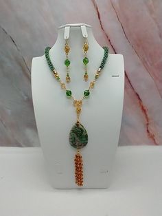 "Handmade and designed by me-one of a kind necklace set-green rainbow seed bead crocheted rope necklace-19\"-5\" long focal with a Mexican crazy lace agate pendant bead and a 3\" seed bead beaded tassel-green and tan glass beads-rose connectors-2 3/4\" long matching dangle earrings-gold tone findings-lobster clasp-1\" extender chain. Add this beautiful necklace set to your jewelry collection-would be an eye catching set for a summer night!" Crochet Gemstone, Green Necklaces, Collar Rosa, Green Rainbow, Jewerly Beads, Bead Crochet Rope, Crochet Rope, Beaded Jewelry Tutorials, Earrings Beaded