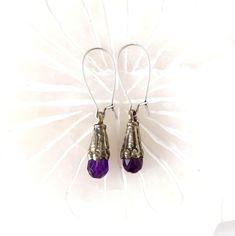 Tibetan amethyst silver earrings. Antique silver dangle earrings with gorgeous purple amethyst.  Ear wires are antique silver. Lightweight and comfortable to wear, 2.00" x .25".  See matching bracelets below. *SIZE* Length is 2.00 inches Width is .25 inches *FREE SHIPPING* I will get your lovely in the mail within 24 to 48 hours.  Shipping is Monday through Friday and mailed USPS first class or priority mail. Tracking number will be sent to you. *MATCHING BRACELETS*: https://www.etsy.com/listing/1584152290 For more delights from Mystic Pieces: Silver Earrings: https://www.etsy.com/shop/mysticpieces?ref=seller-platform-mcnav&section_id=31828678 Bracelets: https://www.etsy.com/shop/mysticpieces?ref=profile_header&section_id=39102386 Back to Mystic Pieces Home Store: https://www.etsy.com/shop Vintage Amethyst Purple Earrings, Handmade Amethyst Purple Earrings, Purple Sterling Silver Teardrop Dangle Earrings, Purple Crystal Earrings With Ear Wire As Gift, Nickel Free Purple Crystal Drop Earrings, Purple Amethyst Drop Teardrop Earrings, Spiritual Amethyst Drop Earrings, Purple Pierced Crystal Earrings As Gift, Purple Drop Crystal Earrings Nickel Free